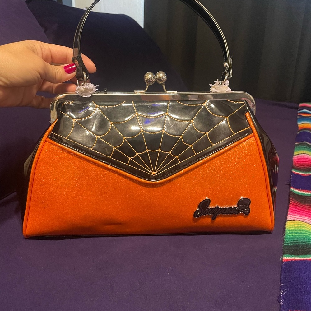 Sparkly orange/black spider web purse.